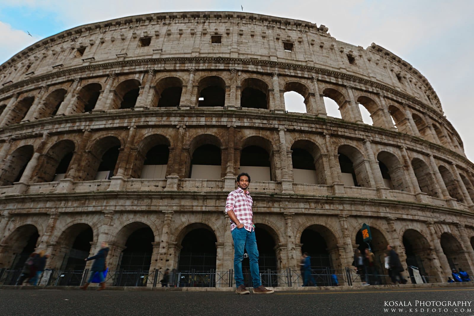 Ramesh standing in front of the Colosseum